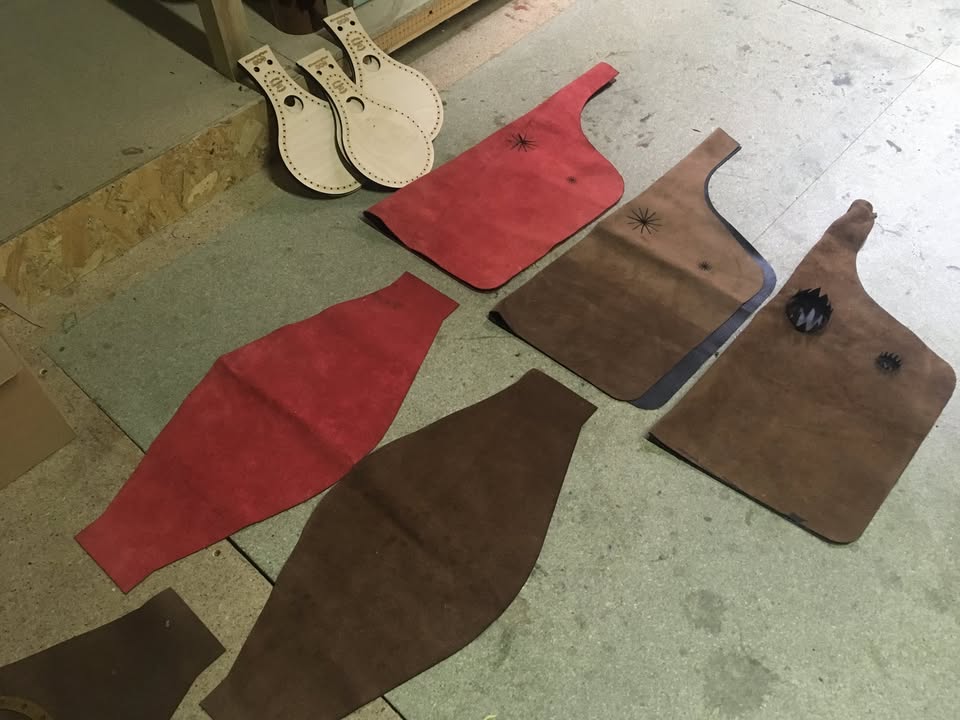 Leather, bellows cheeks and fittings laid out for making.